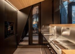 Polar Life Haus, modern dark-toned kitchen in a hybrid house