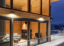 Snow-covered terrace of a solid wood house