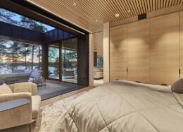 Large windows bring nature into the bedroom of the solid wood house