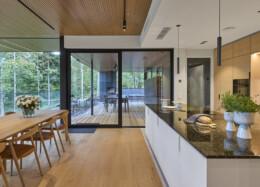 Sliding glass doors connecting the kitchen and dining area to the terrace